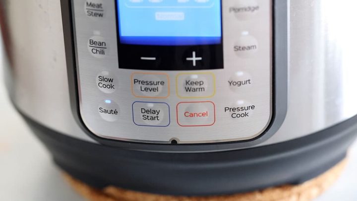 Front view of the instant pot with "Saute" turned on