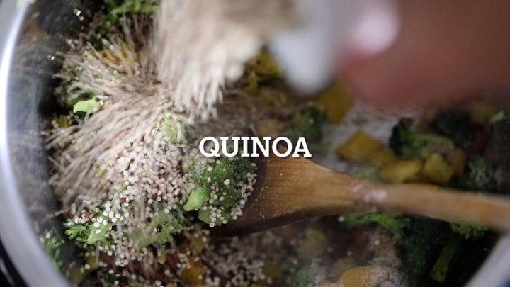 Uncooked quinoa being added to the other ingredeitns
