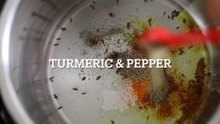 Turmeric and black pepper being added to the instant pot container
