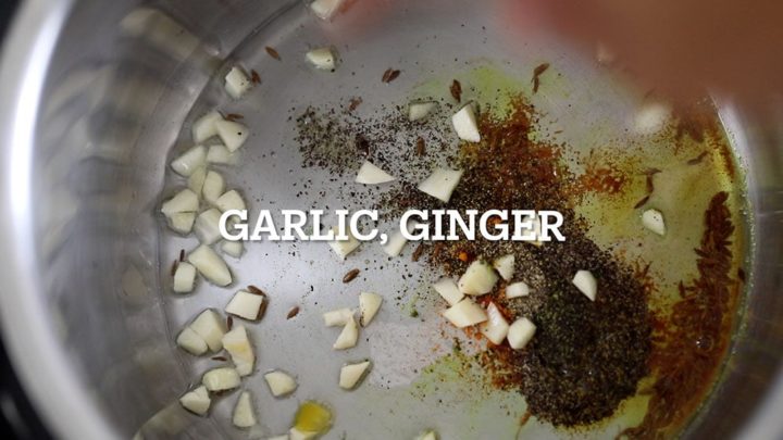 diced garlic and minced ginger being added to the instant pot
