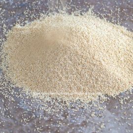 front view of amaranth grains being piled into a cone shape