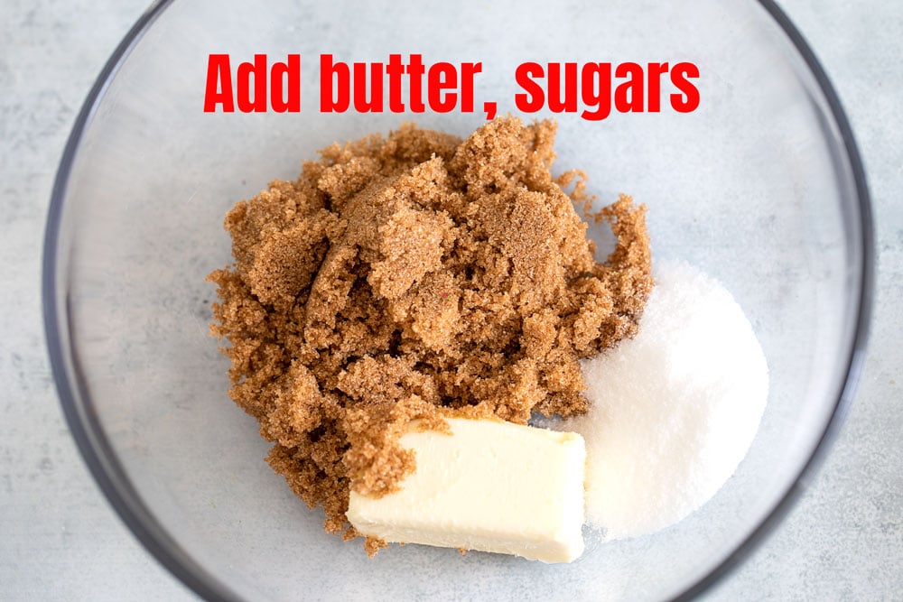 Dark brown sugar, granulated sugar and softened butter stick in the glass bowl.