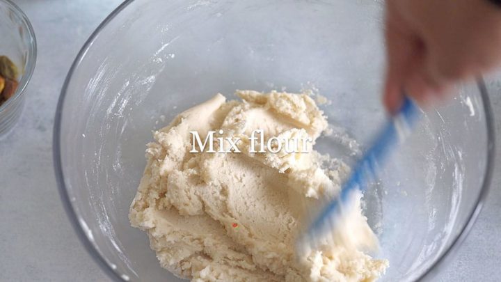Top view of the author mixing the flour with a blue silicone spatula