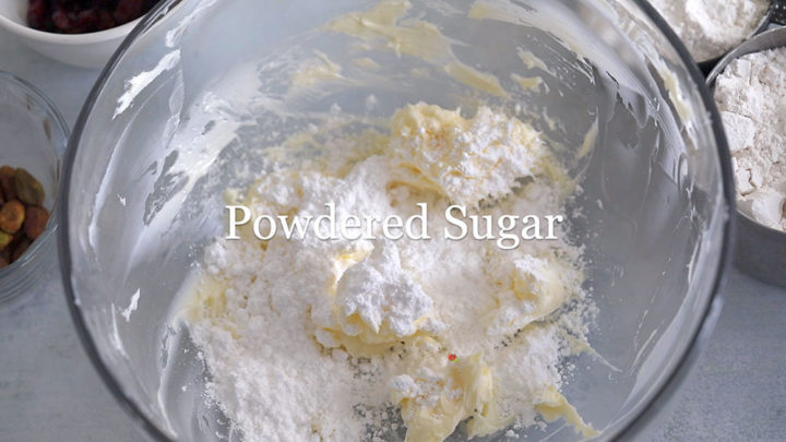 Top view of powdered sugar added to the creamed butter