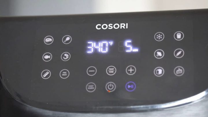 Front view of a COSORI Air fryer displaying the cook tempreture of 340°F and 5 Min Cook time