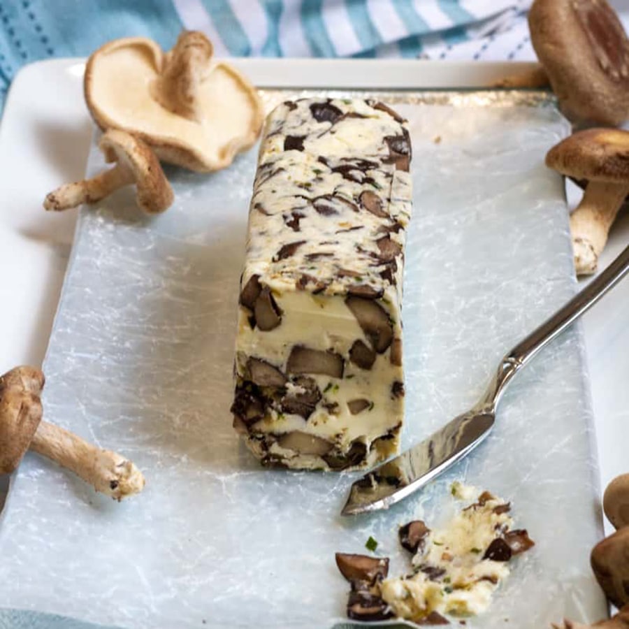 front view of a log of butter with mushrooms in it.