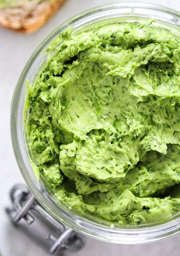 top and closeup view of a green colored butter in a mason jar