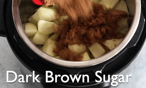 The author adding dark brown sugar to the instant pot