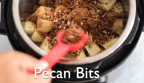 The author adding pecan bits using a red measuring spoon