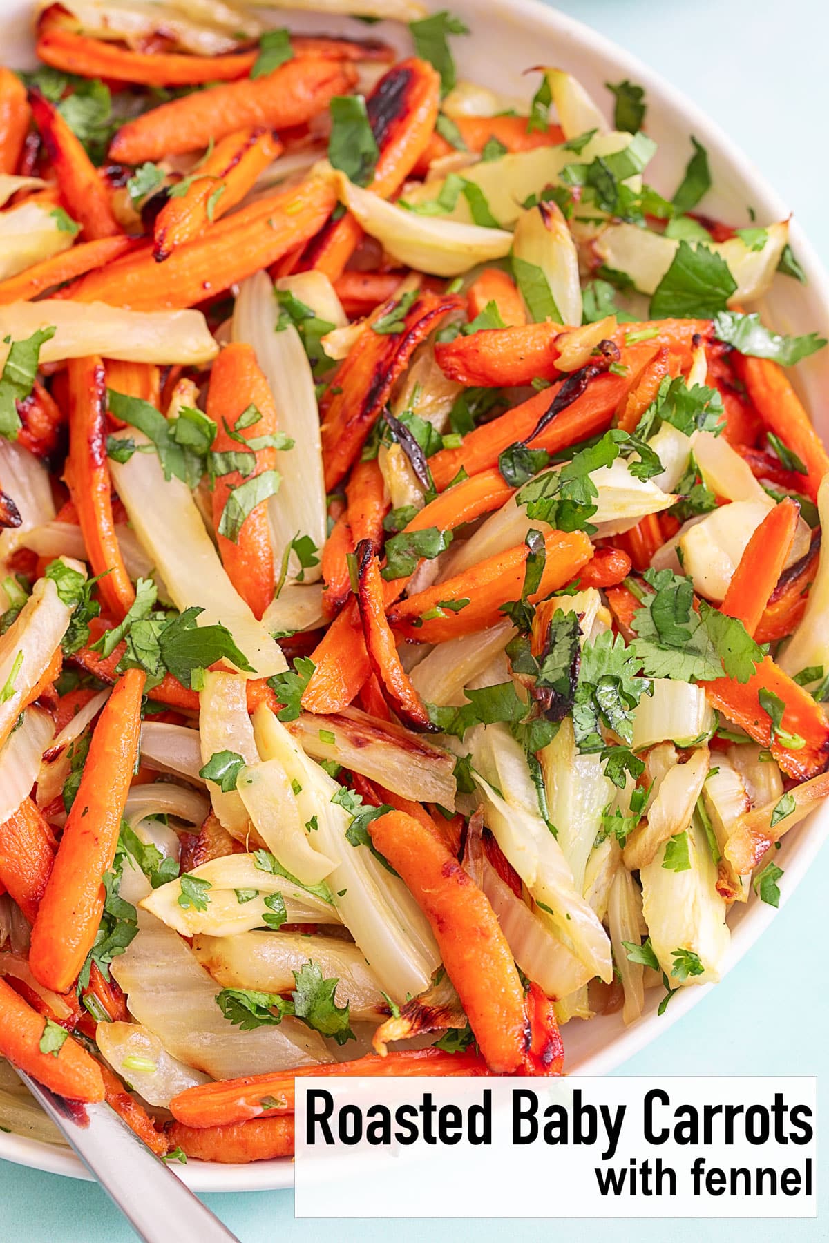 Top view of a bowl filled with carrots and fennel with cilantro garnish - Roasted baby carrots