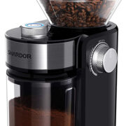 A sleek black and stainless steel coffee maker with a container for coffee grinder on top.