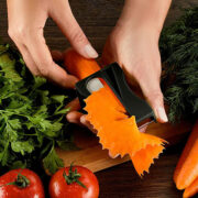 A carrot being sharpened using a large hand held sharpner