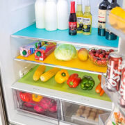 front view of shelves in a refrigerator lined with colorful silicon liners. - foodie geek gift guide