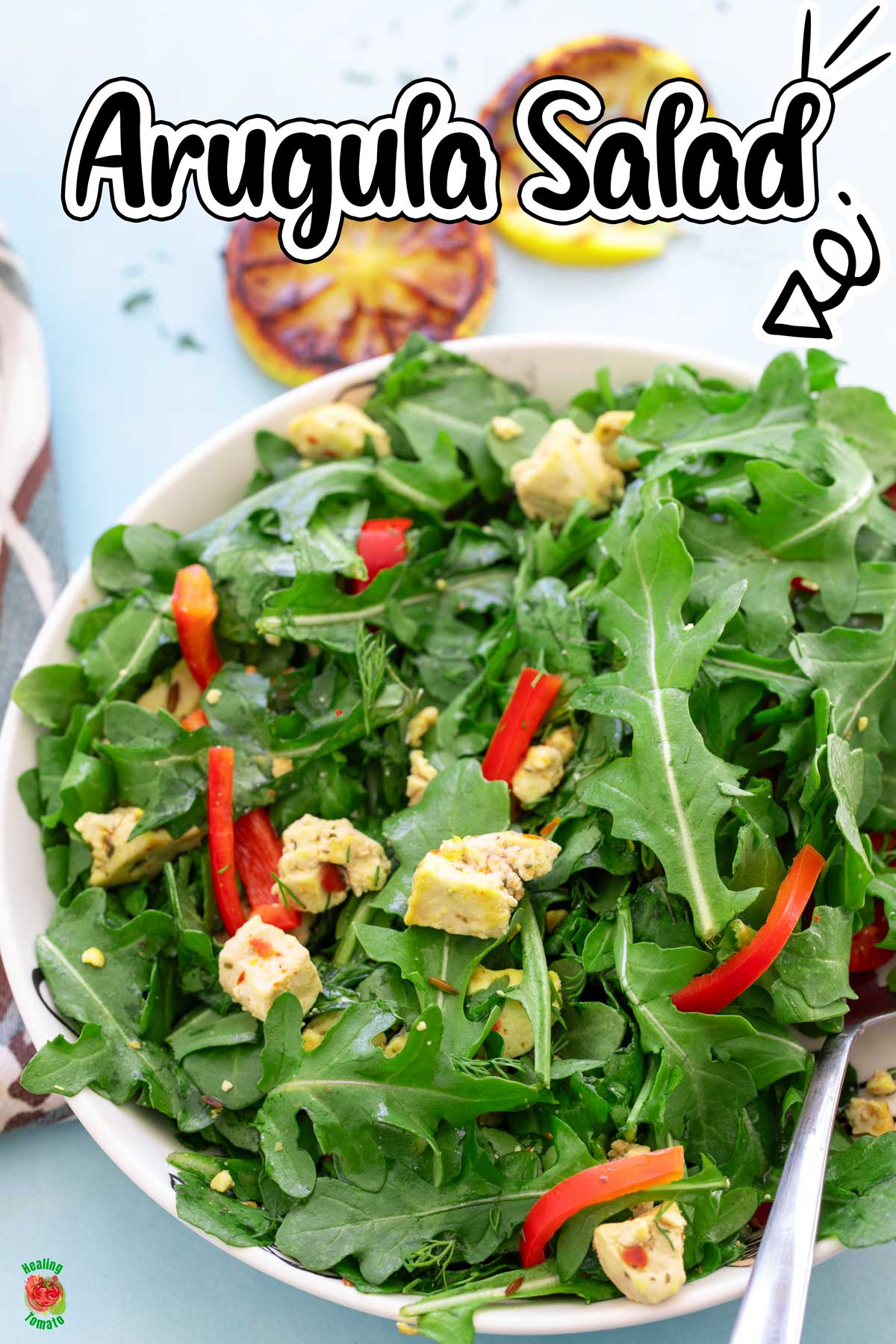 Top view of arugula, tofu and mini sweet peppers in a bowl