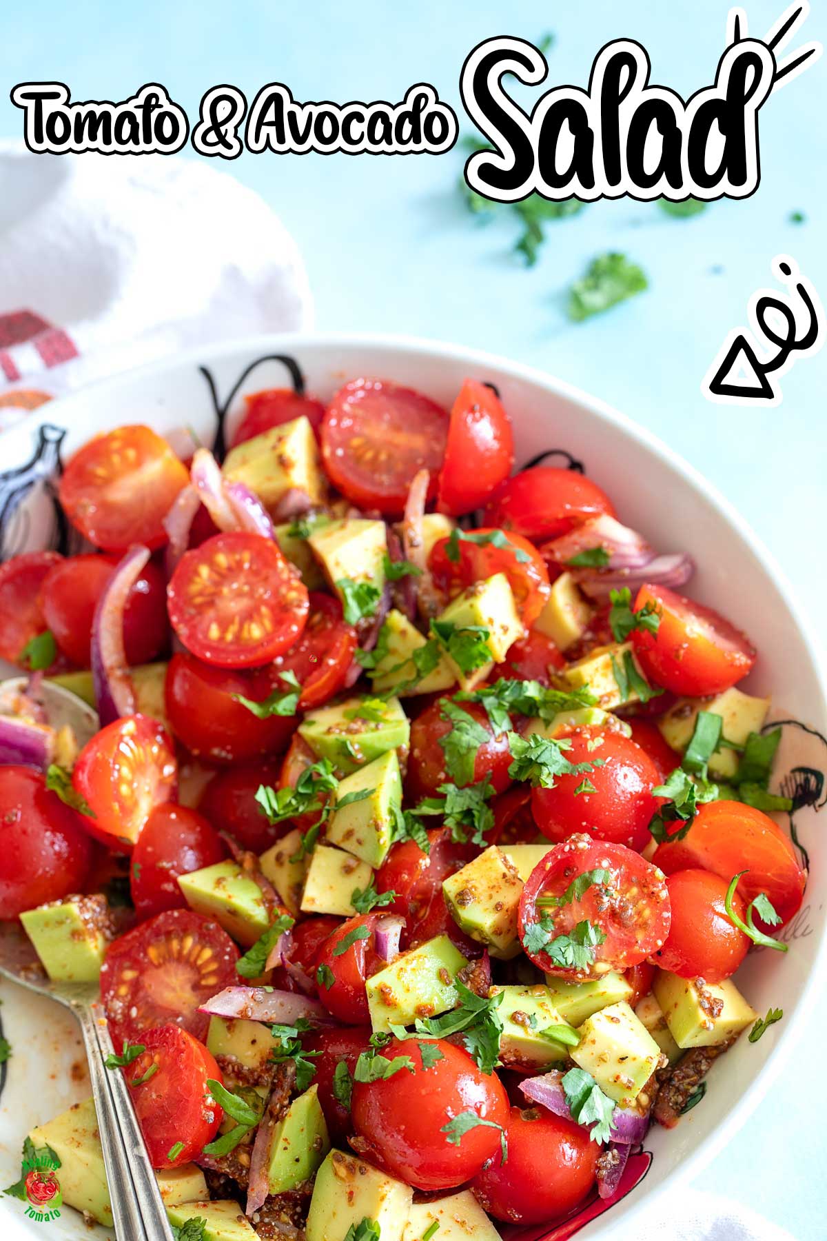 Top view and closeup of tomato avocado salad in a white bowl with a serving spoon in it