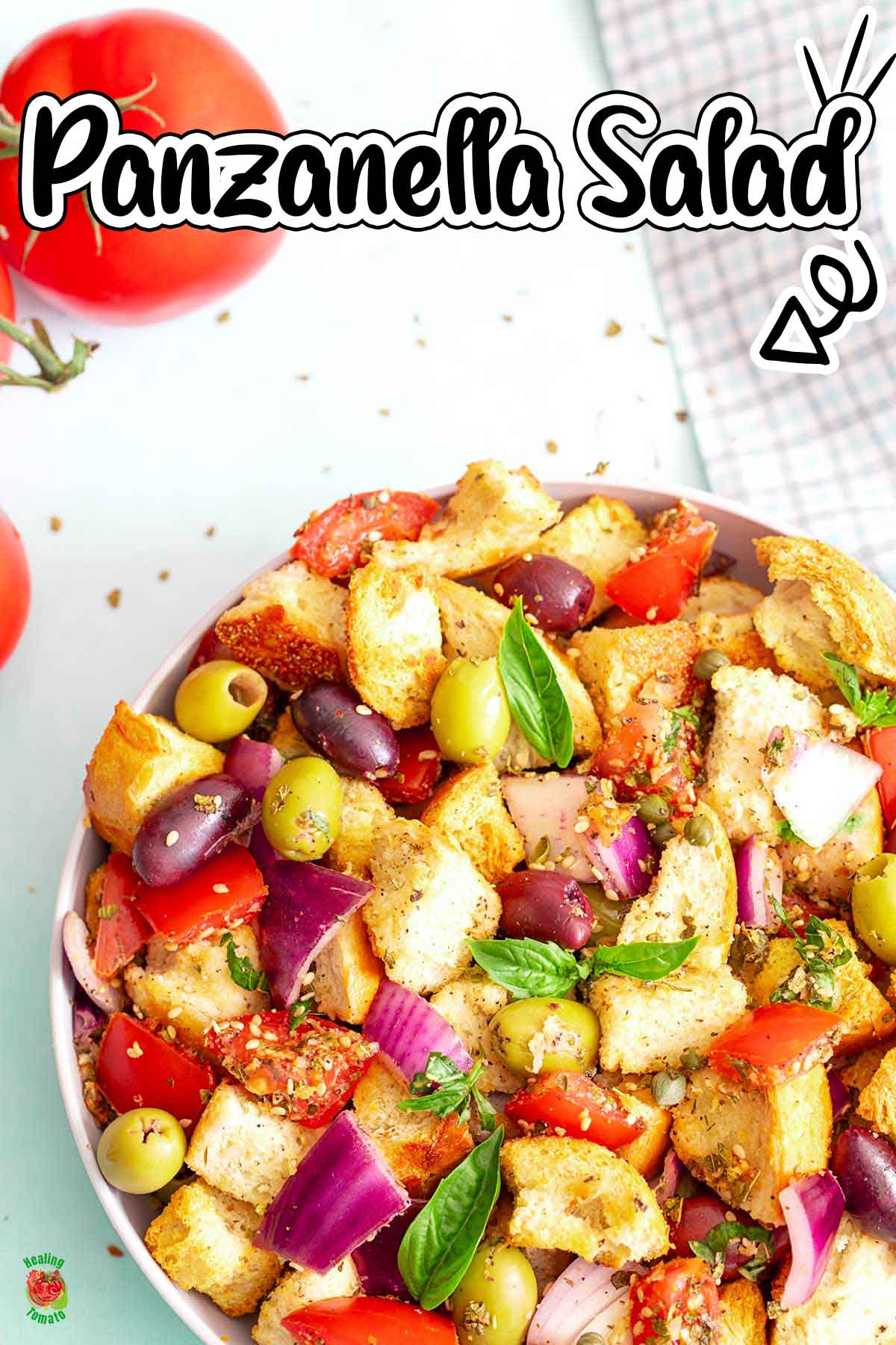 Top view of panzanella salad in a white bowl.