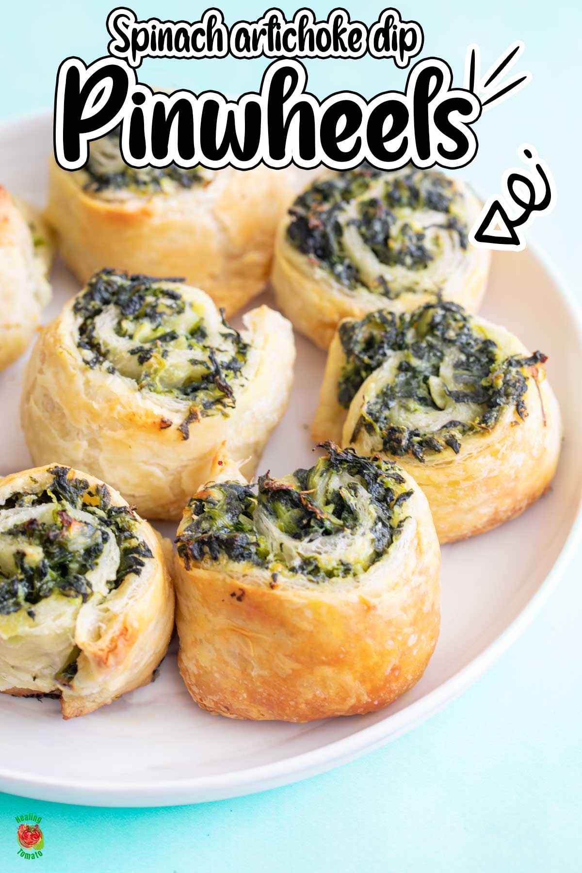 Front view of a white plate filled with puff pastry pinwheels.