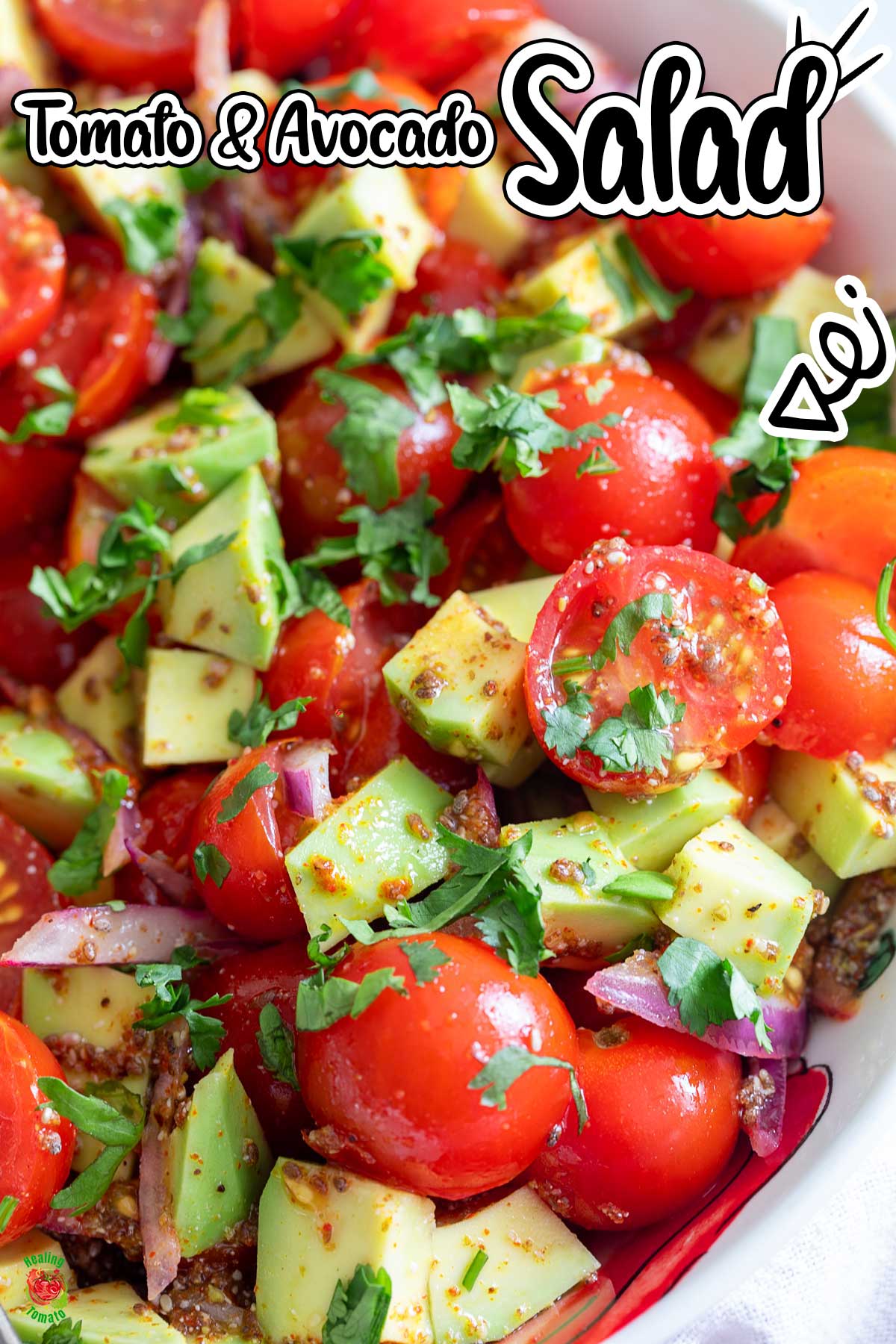 Closeup of tomato avocado salad in a white bowl.