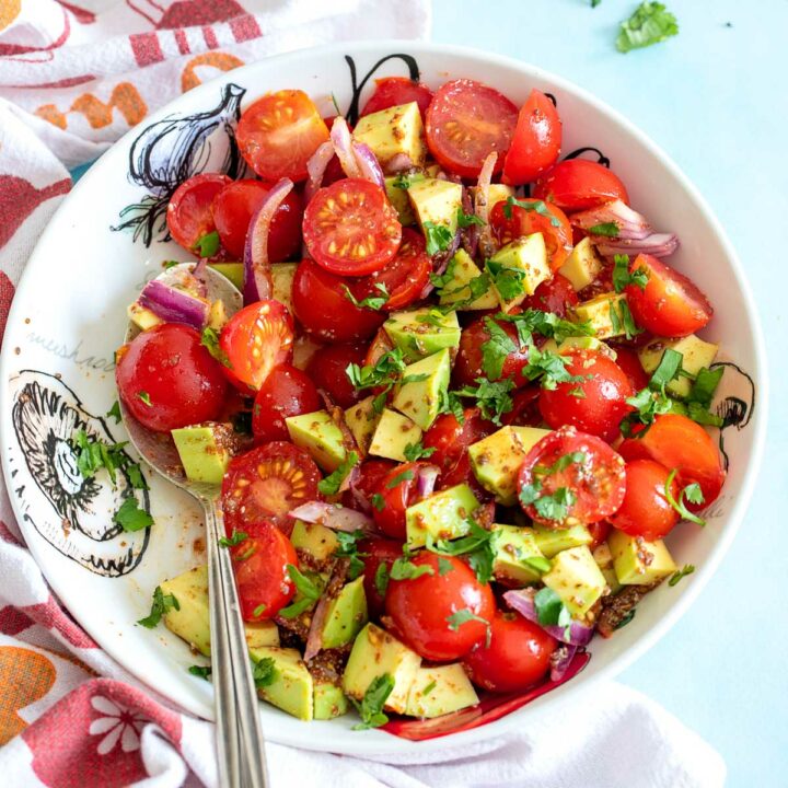 Top view of avocado salad in a white bowl
