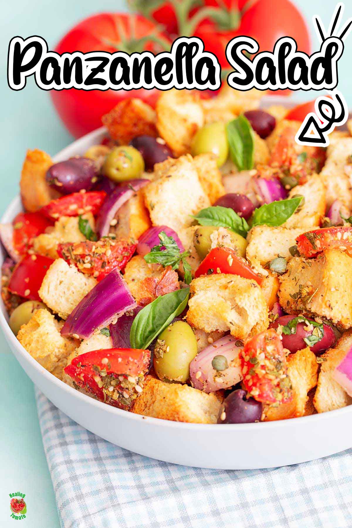 Front viewo of bread salad with olives, tomatoes, bread, onions and capers.