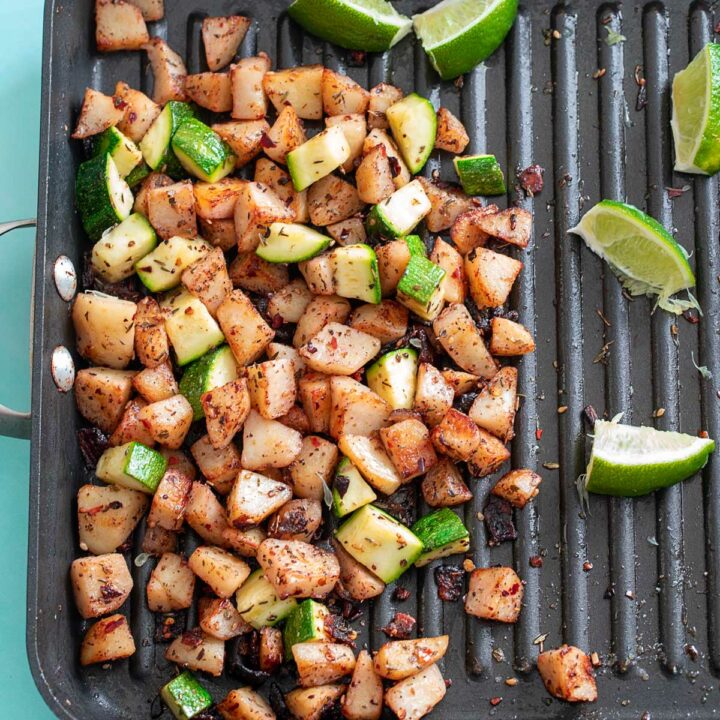 Top view of breakfast potatoes with zucchini in a stove top grill