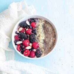 Closeup of greek yogurt bowl with berries, hemp seeds and chia seeds