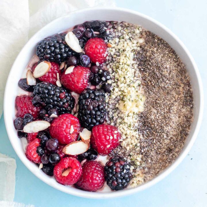 Closeup of greek yogurt bowl with berries, hemp seeds and chia seeds