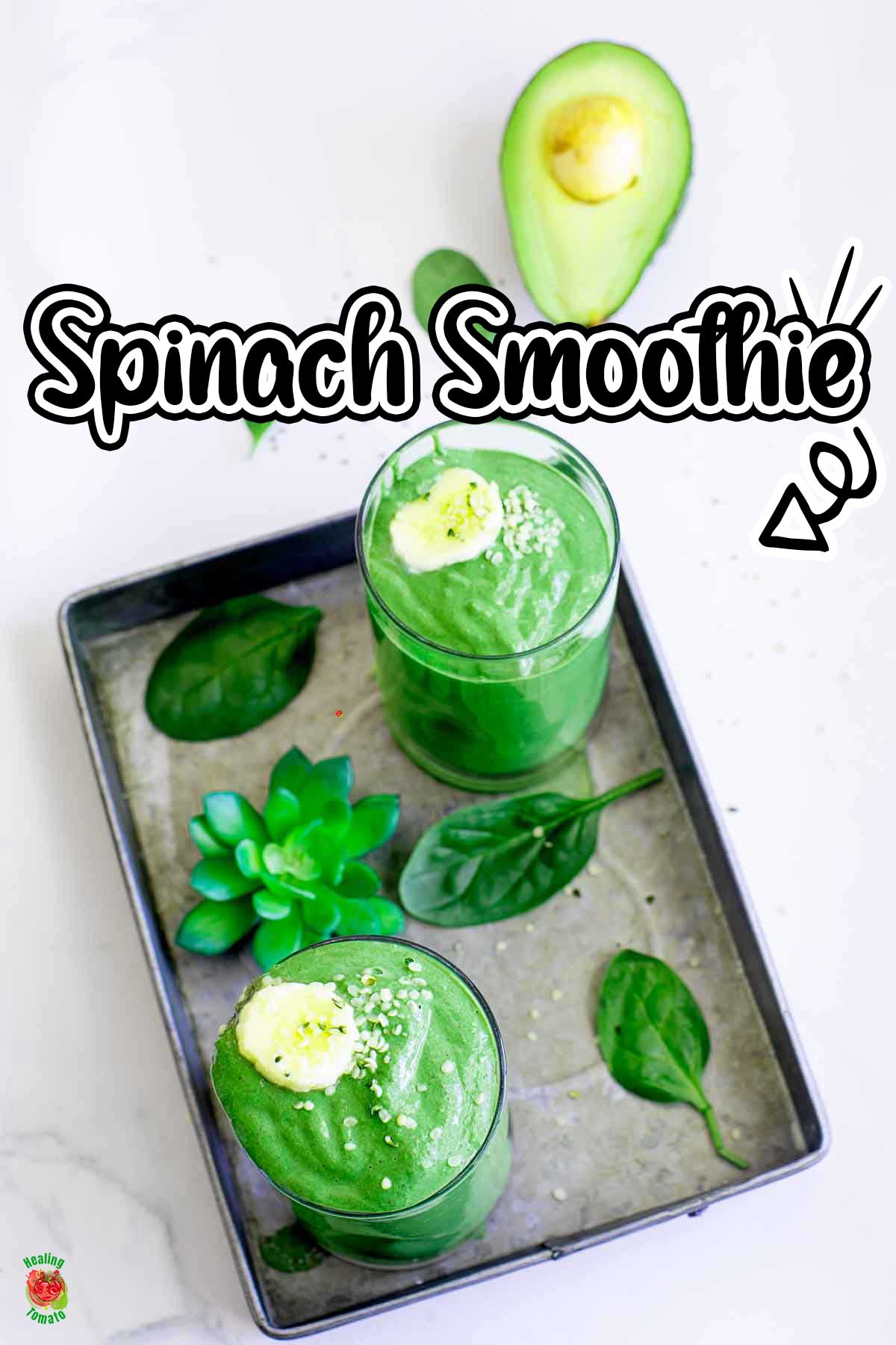 overhead view of 2 glasses filled with spinach smoothie on a grey tray.