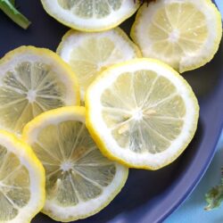 Top and closeup view of lemon slices on a blue plate