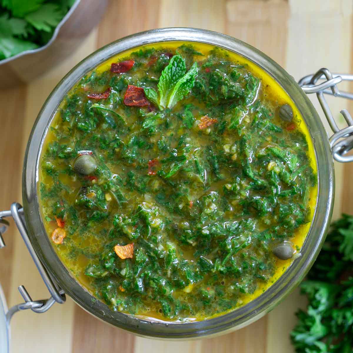 Top and closeup view of chermoula sauce in a glass jar