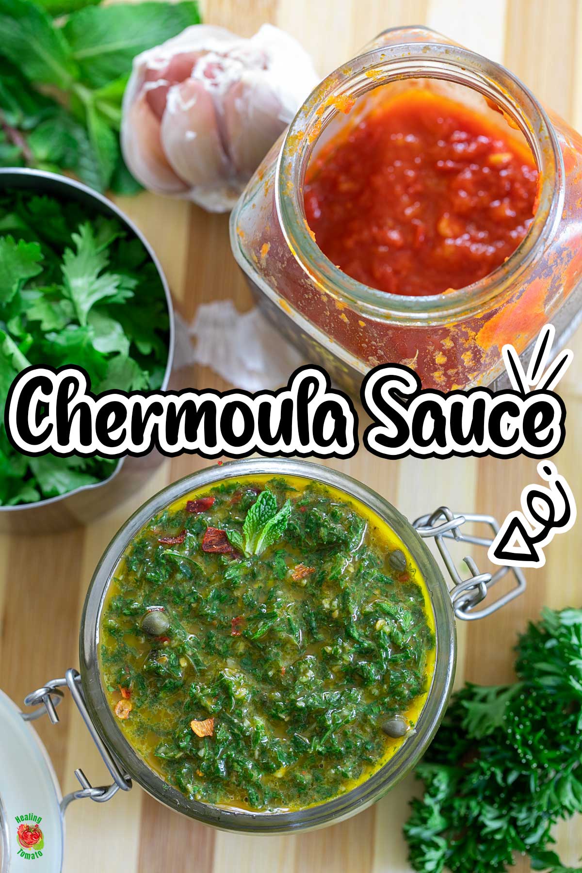 Top and closeup view of chermoula sauce in a glass jar. Jar is surrounded by fresh herbs, garlic and harissa paste.