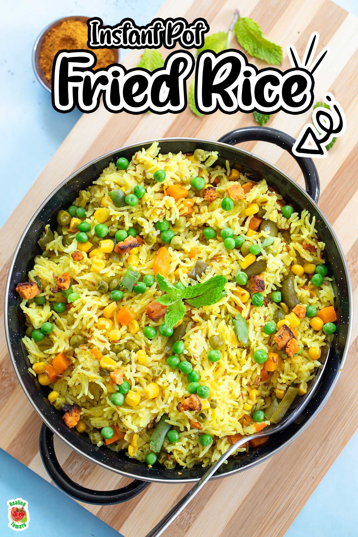 Top view of a pan filled with corn, peas, green beans and carrots cooked with basmati rice.