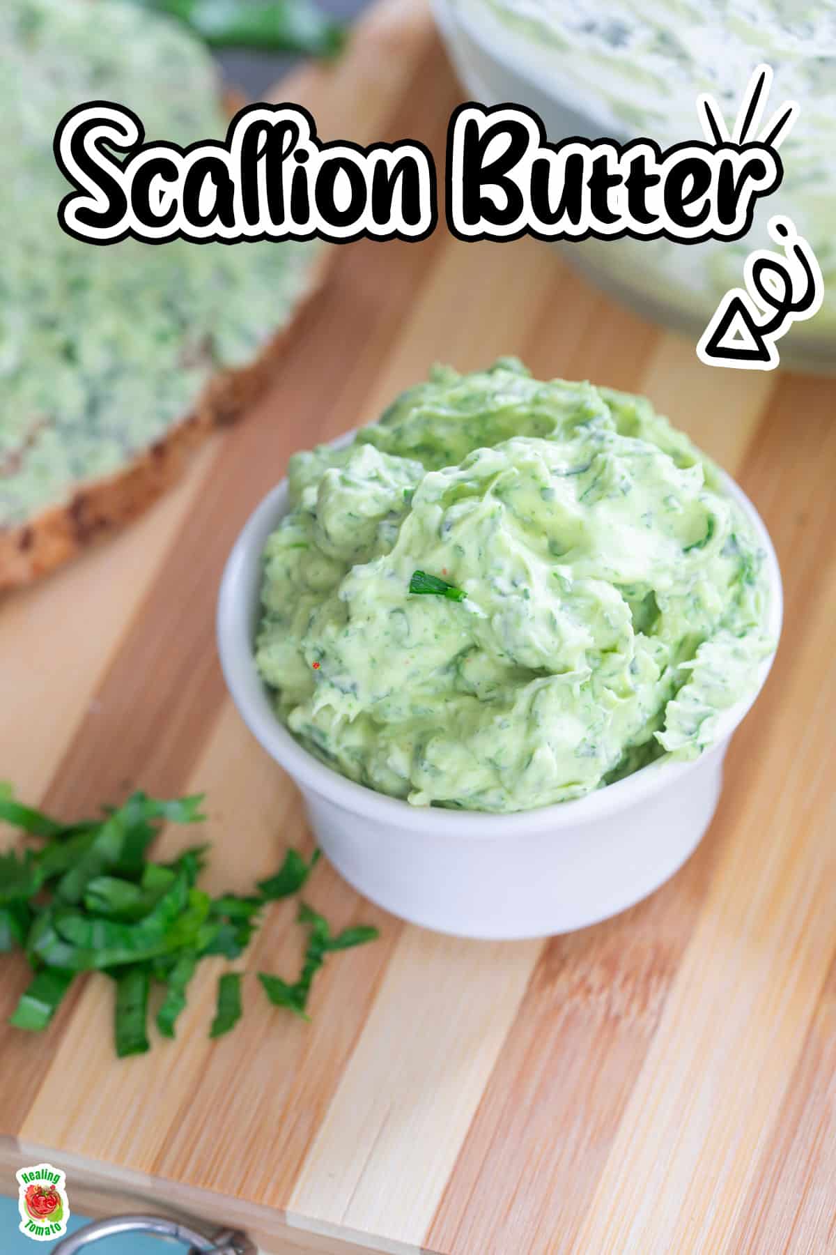 Angle view of scallion butter in a white ramekin.