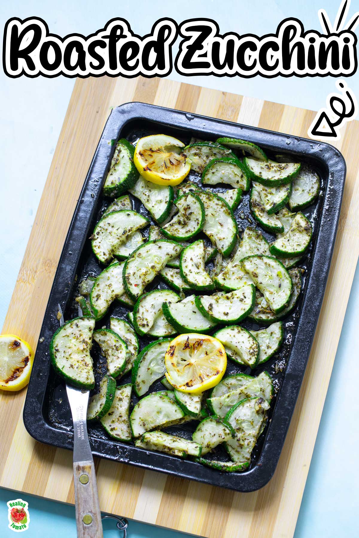 Top view of roasted zucchini in a sheet pan with grilled lemon slices for garnish