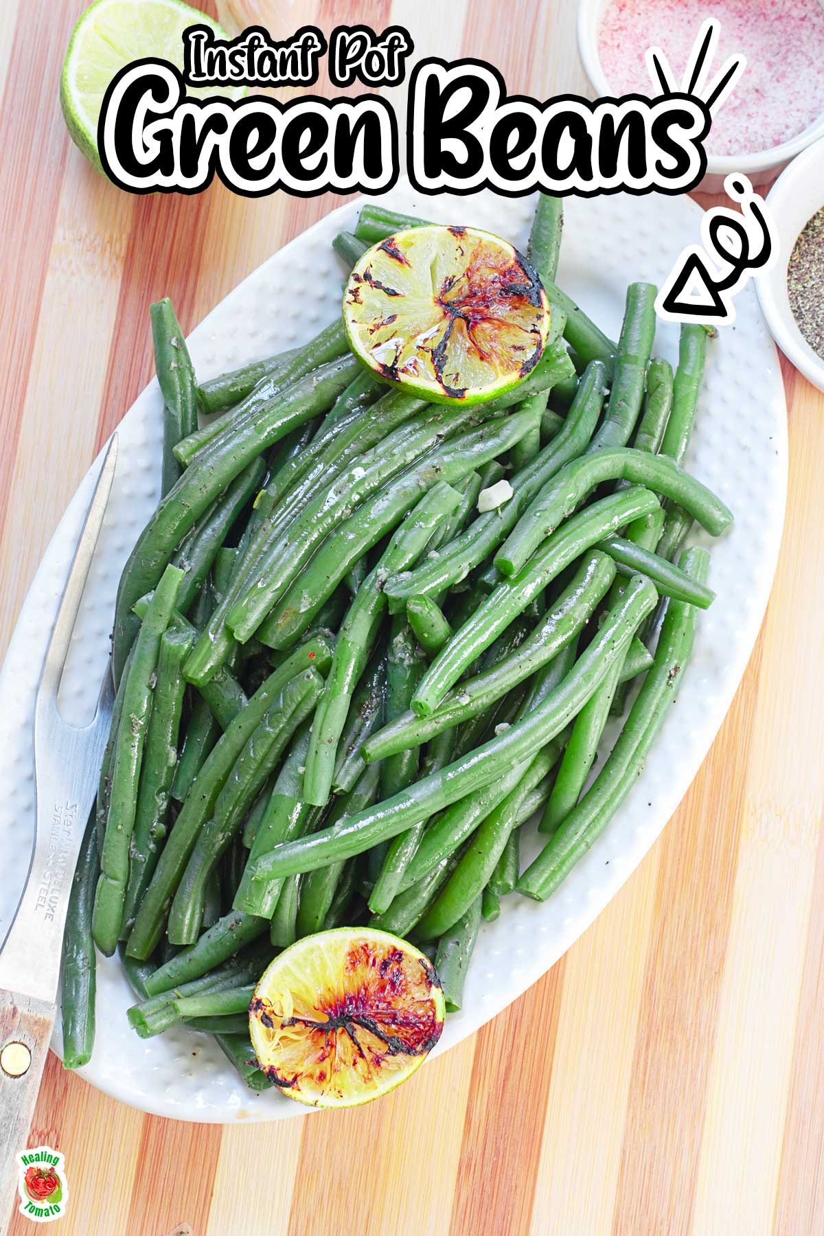 Top view of green beans in a white serving dish placed on a brown cutting board