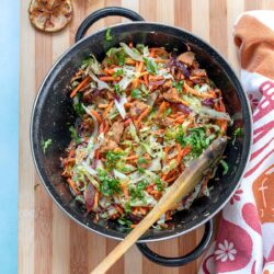 Top view of a black pan filled with sauteed cabbage recipe